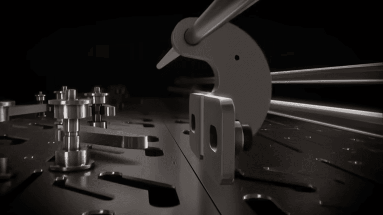 Original frame from the METAGRIP demonstration showing the internal slotted locking plate, upright cam and connected rods.